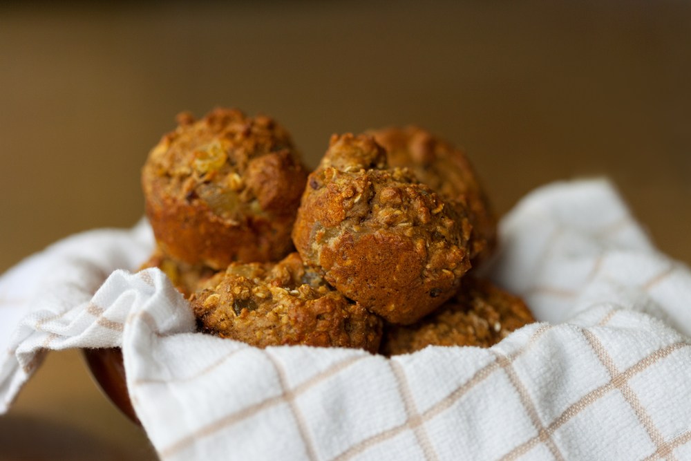Gluten-free muffins sitting in a towel in a bowl.