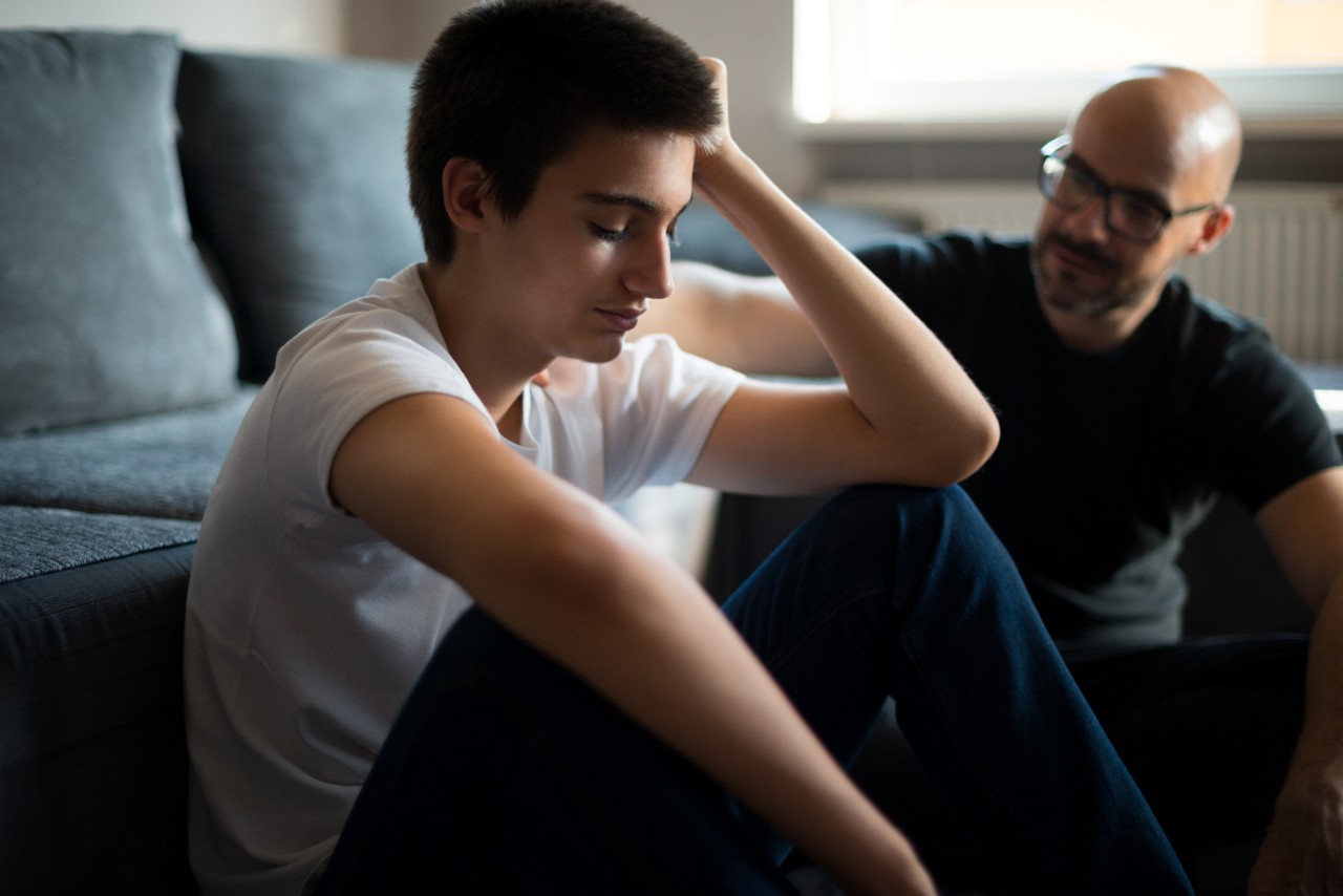 Upset young man talking with his father.