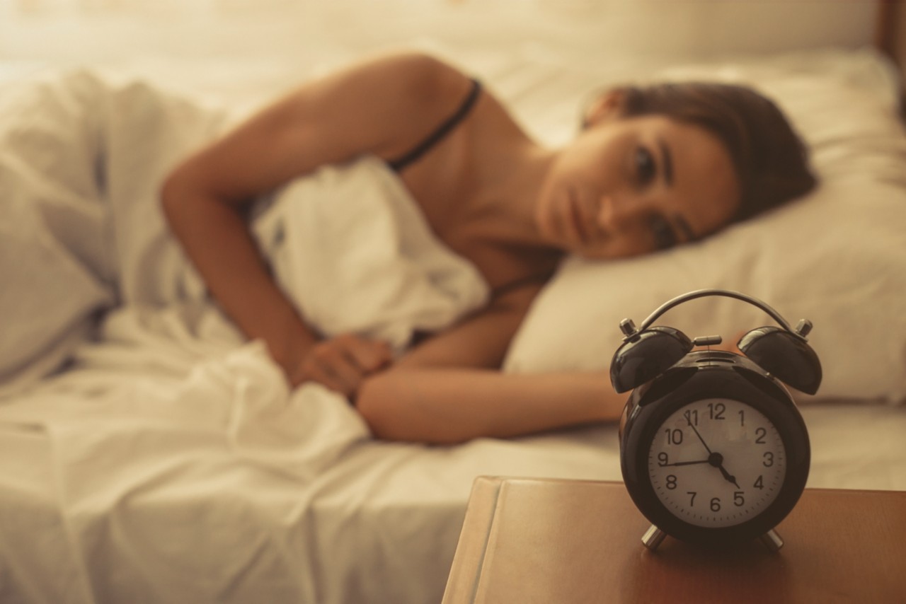 821634668 Young woman lying in bed