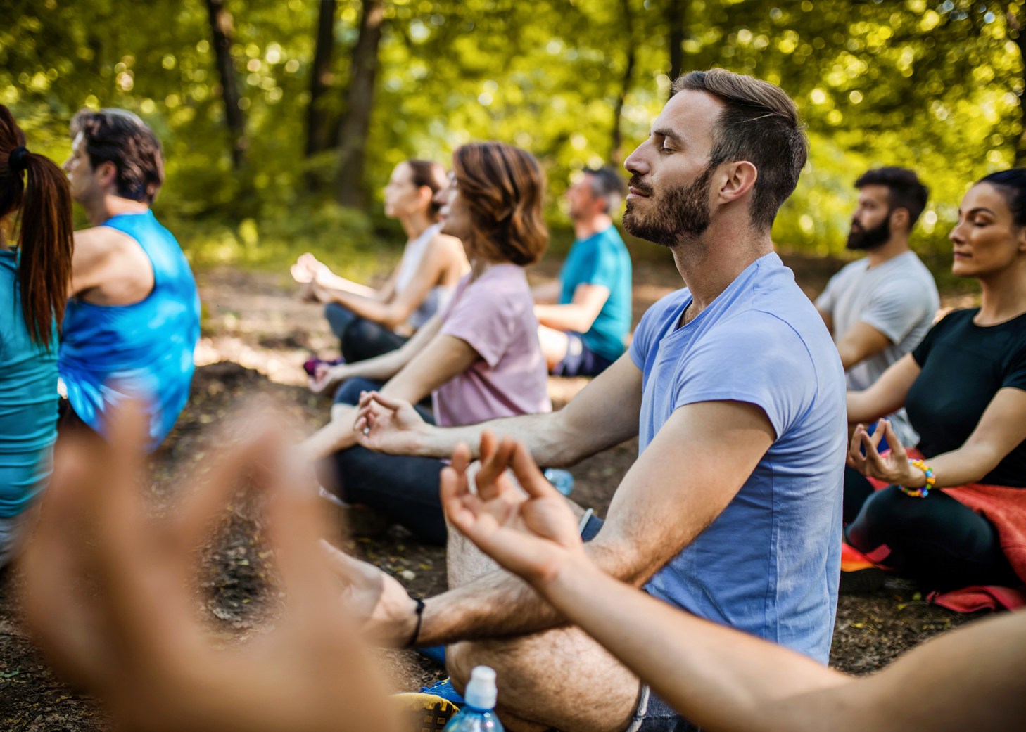 Group of people doing yoga in the woods.