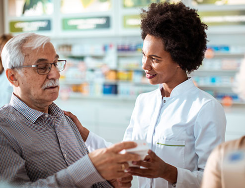 Close up of a senior couple consulting with their local pharmacist