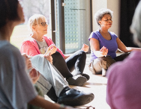 Group of senior women doing yoga. 