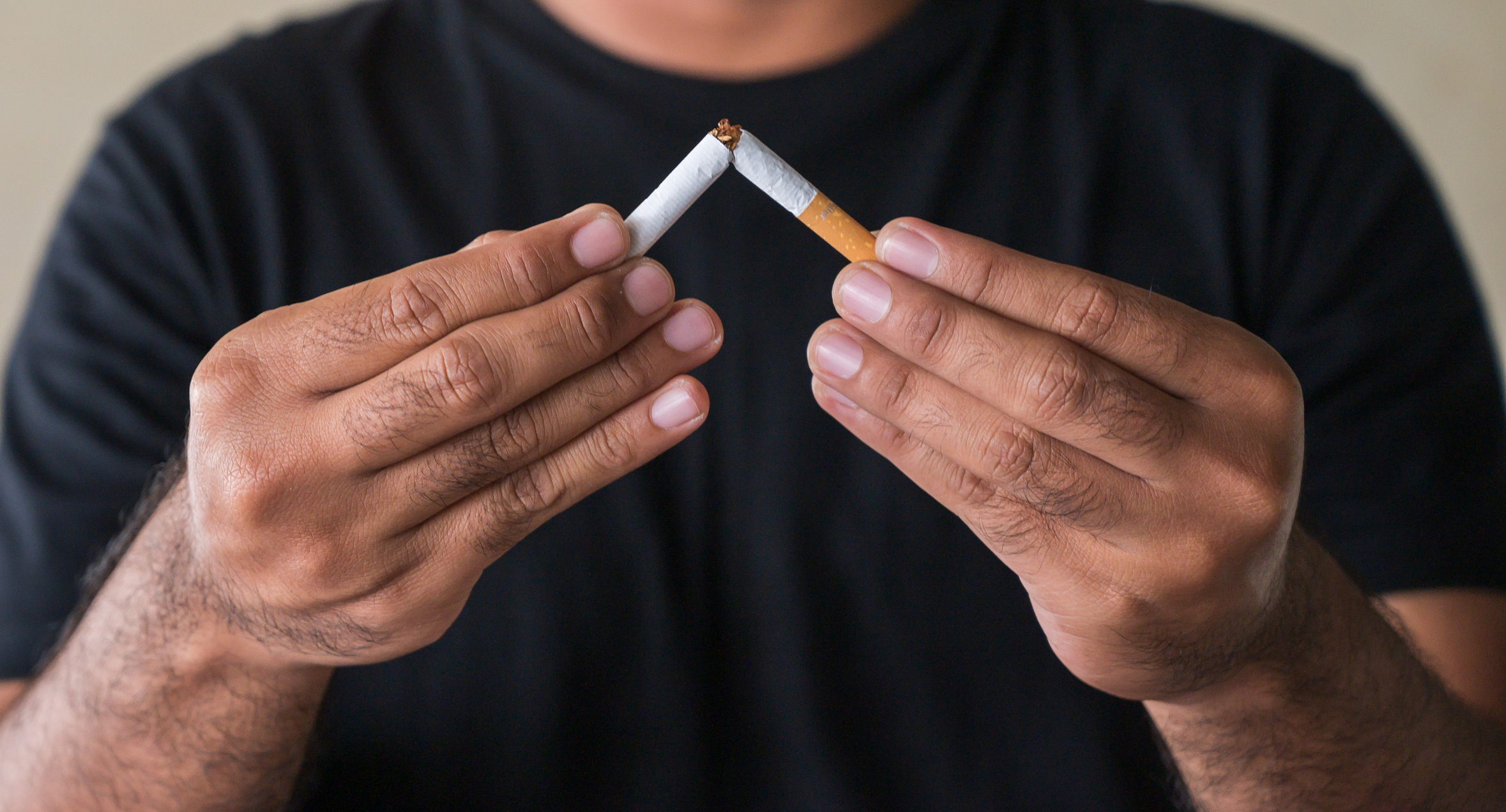 Close up hand  breaking the cigarette. Quit smoking concept