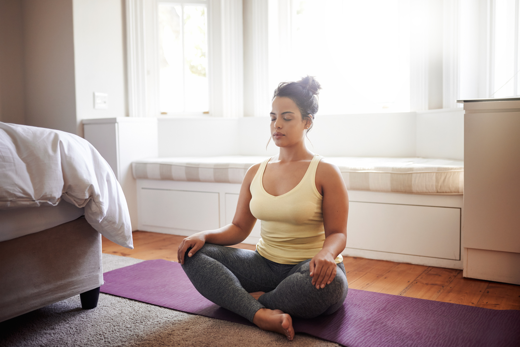 Shot of a beautiful young woman practicing yoga at home