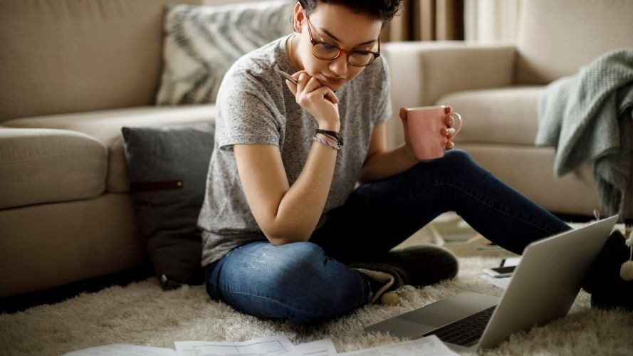 Woman at home on laptop reviewing health insurance benefits