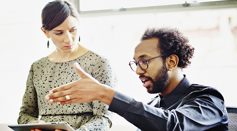 Businessman and businesswoman discussing project in office