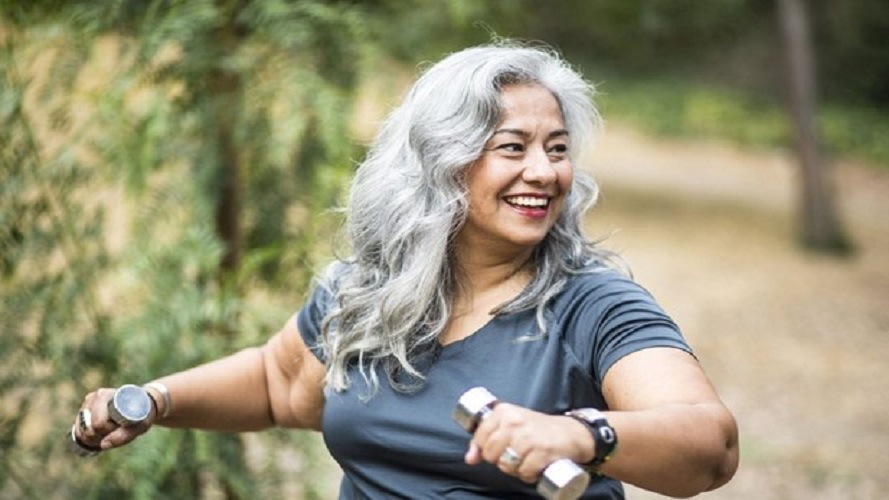 woman long grey hair exercising with weights