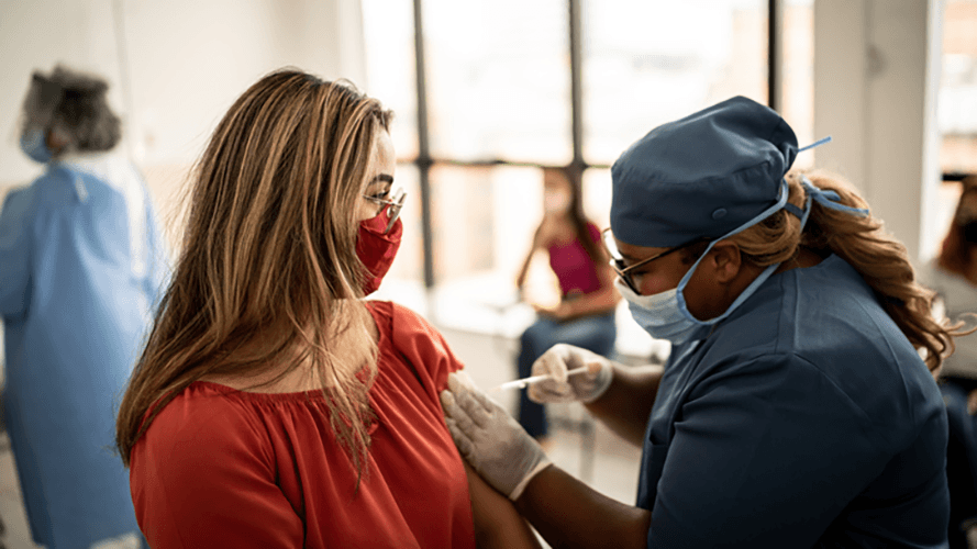 woman receives flu vaccine