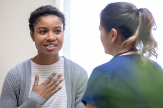 Nurse explaining good news to female patient