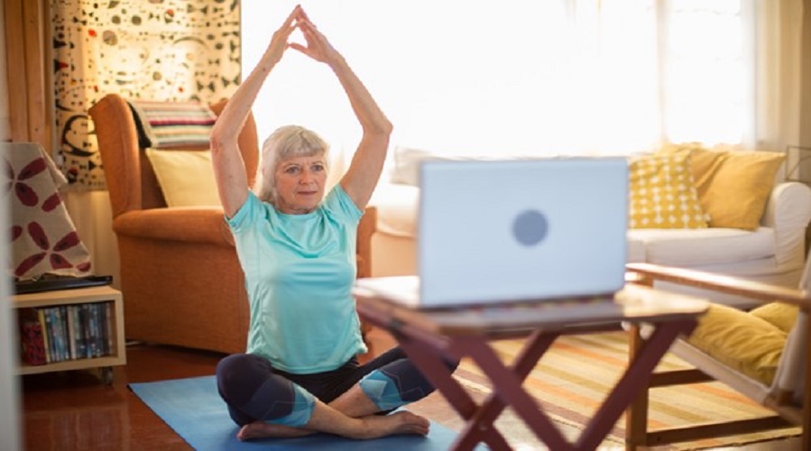 gray haired woman in yoga pose