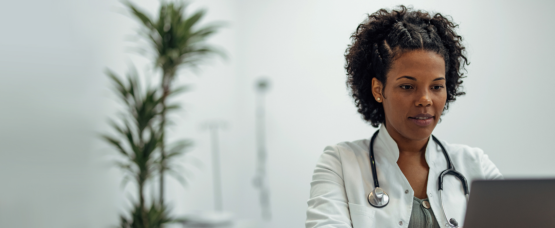 African American Female Doctor navigating the Provider Portal on a laptop