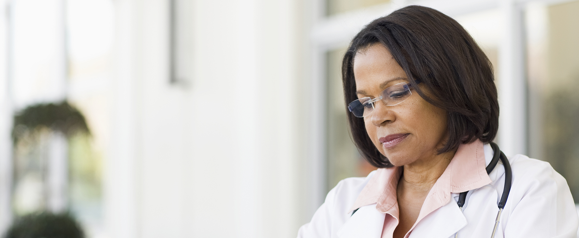 Female African American doctor reviewing preauthorization information
