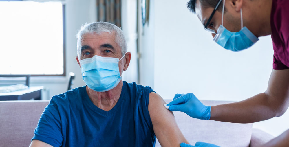 older man getting vaccine