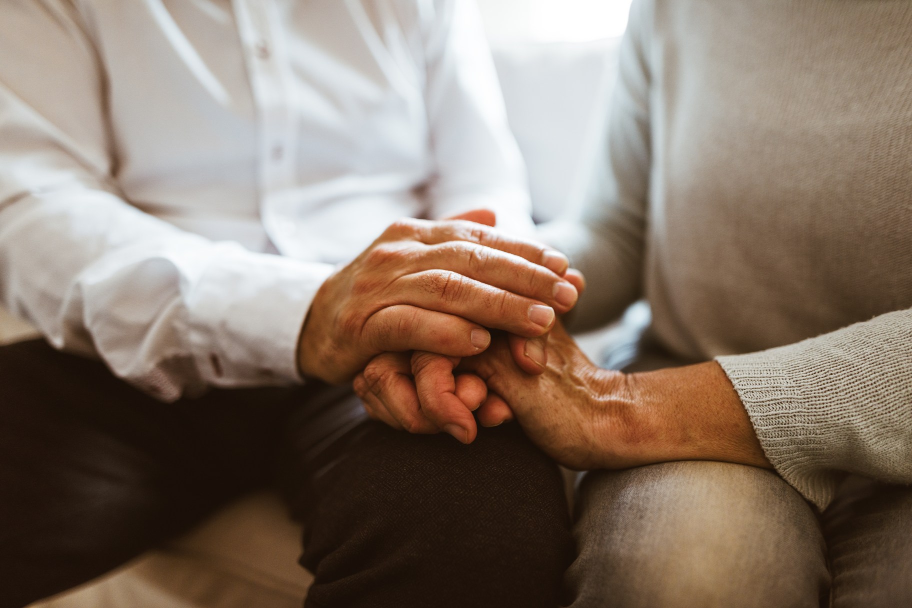 retirement couple holding hands