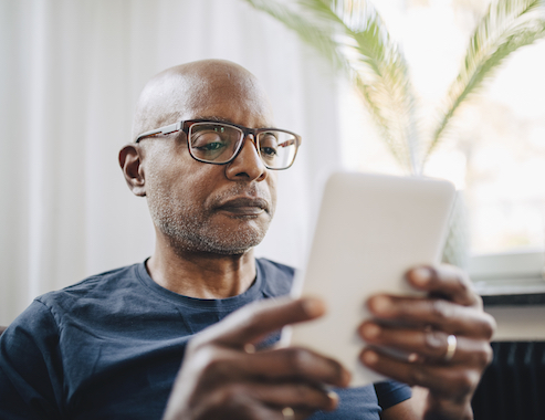 senior man is using his Ipad for looking medicare plans