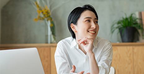 Young female is sitting in front of her laptop