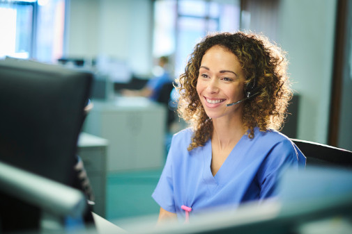 Young female nurse at computer