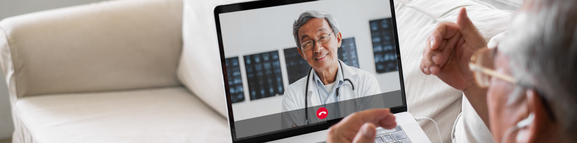 Older man using telehealth on a laptop