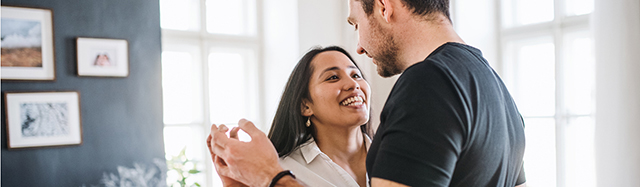 A young woman and man spending time together indoors.