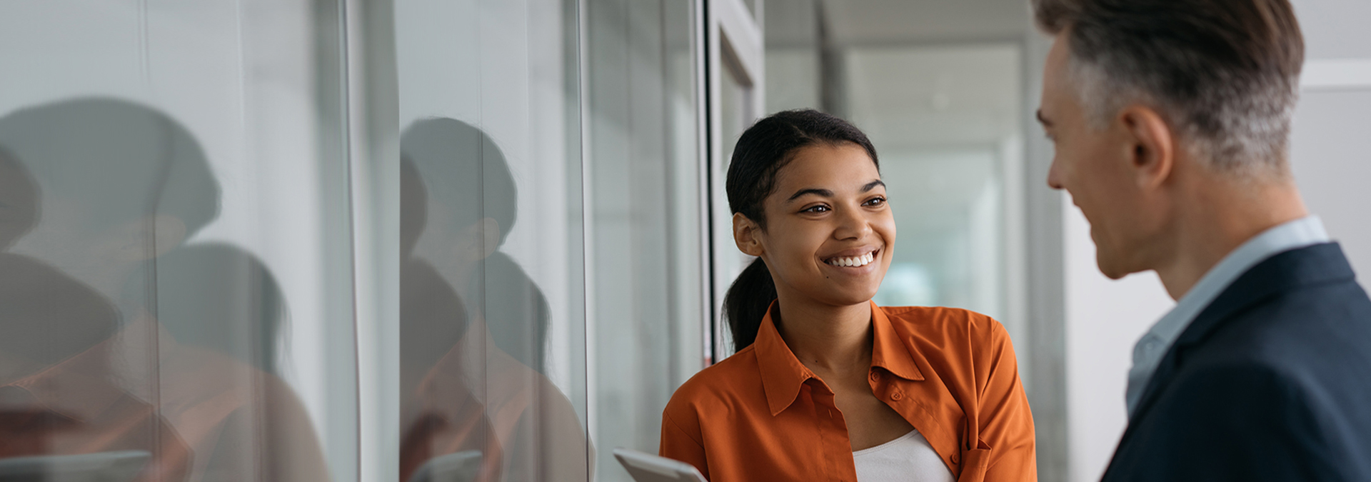 Smiling business people meeting, talking, working together in modern office. 