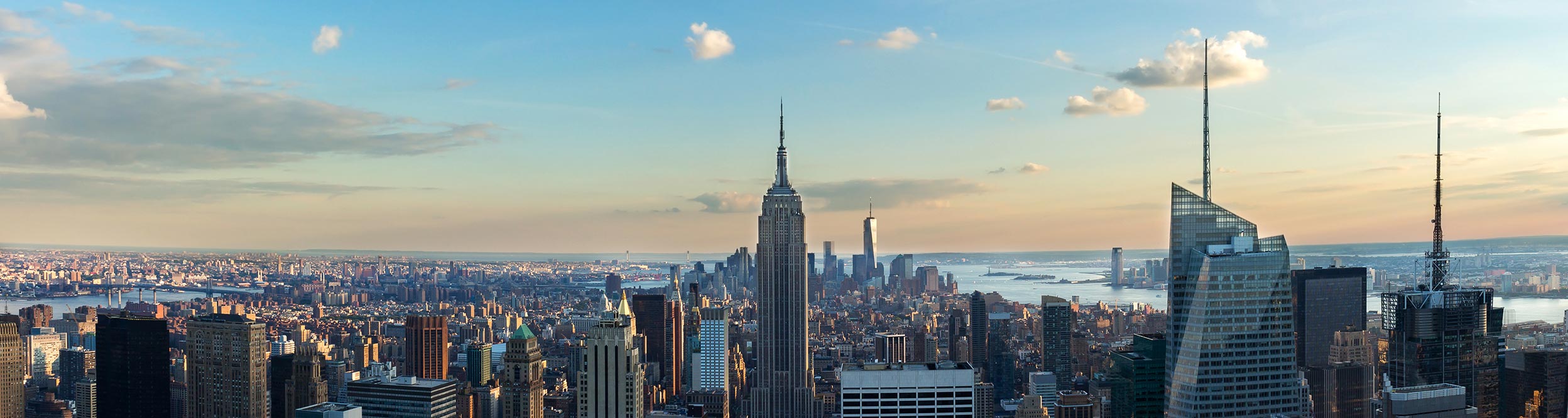 View of New York skyline with blue skies.