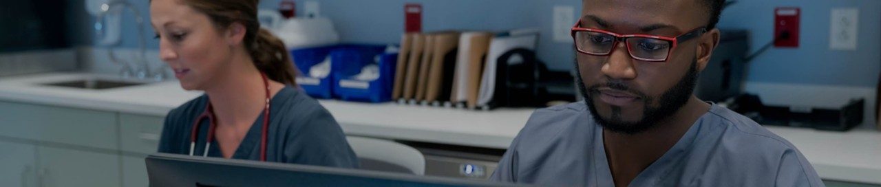 Two doctors behind reception desk