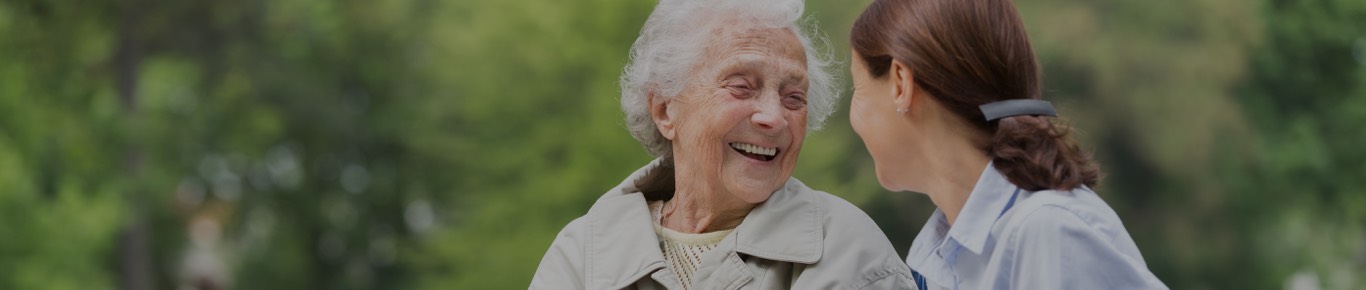 two woman looking at each other and smiling