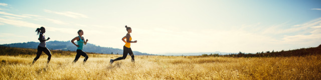 Three women jogging on sunny day