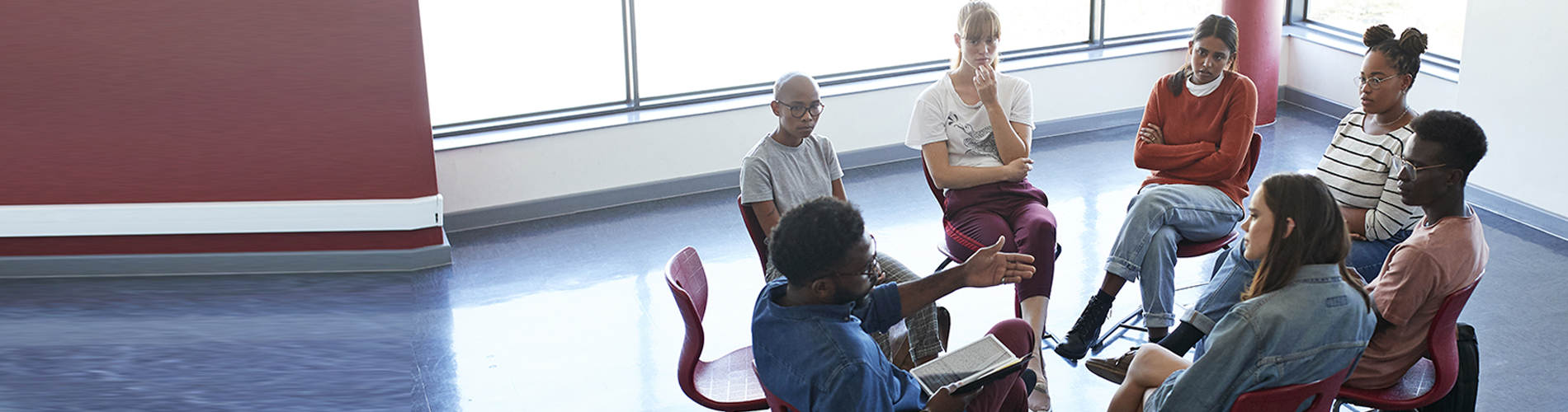 group of people with a health coach sitting in a circle