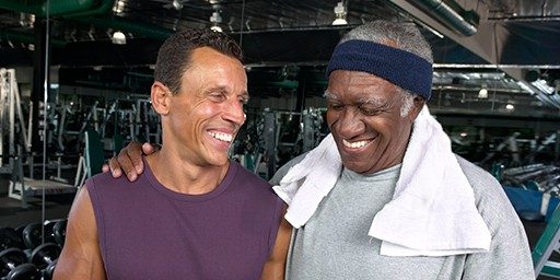Two men are happy after workout session at fitness center.