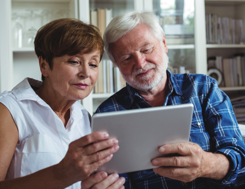 Older man and woman looking at a tablet PC.