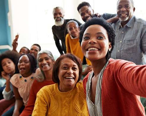 Group of people smiling and taking picture. 