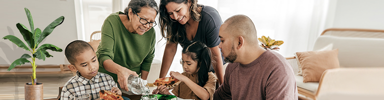 Multi-ethnic family having pizza