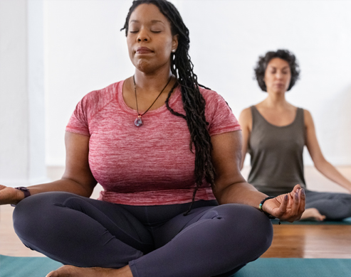 Group of people doing breathing exercises and meditation