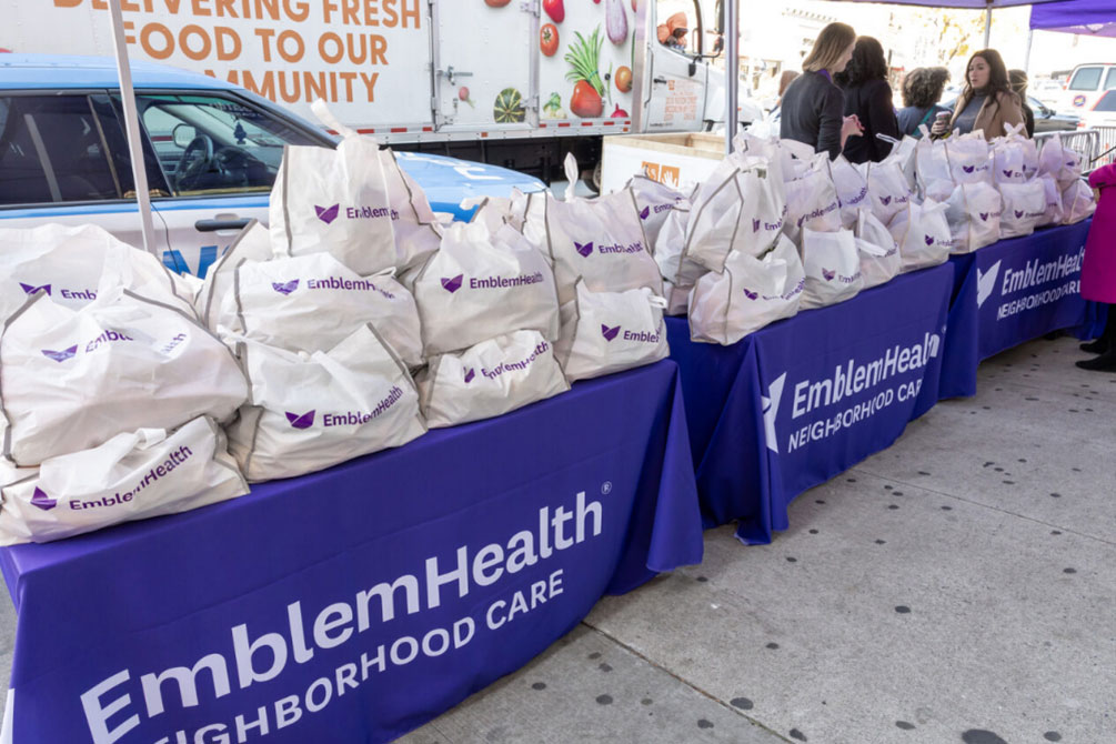 EmblemHealth purple table at their Turkey Giveaway in collaboration with The Campaign Against Hunger in November 2023. Over 3,000 turkeys were distributed across the Bronx, Brooklyn, and Queens.