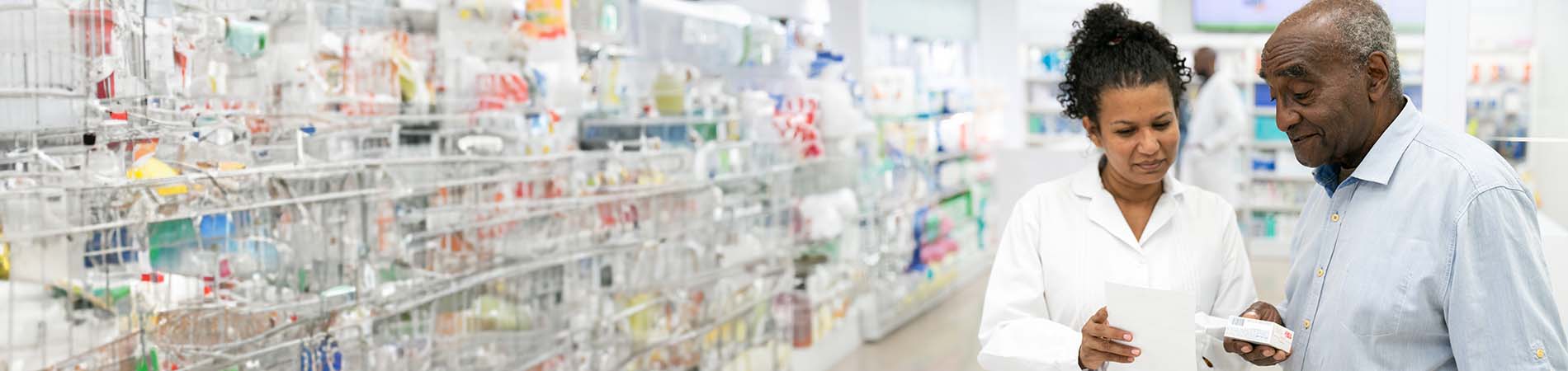 Pharmacist helping senior customer with prescription medicine