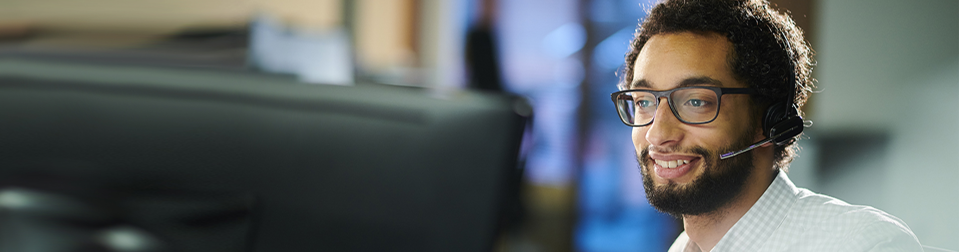 a male call center worker takes a call.