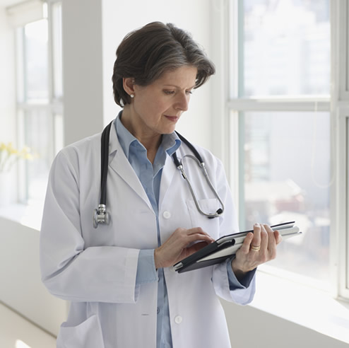 Doctor using tablet device at hospital