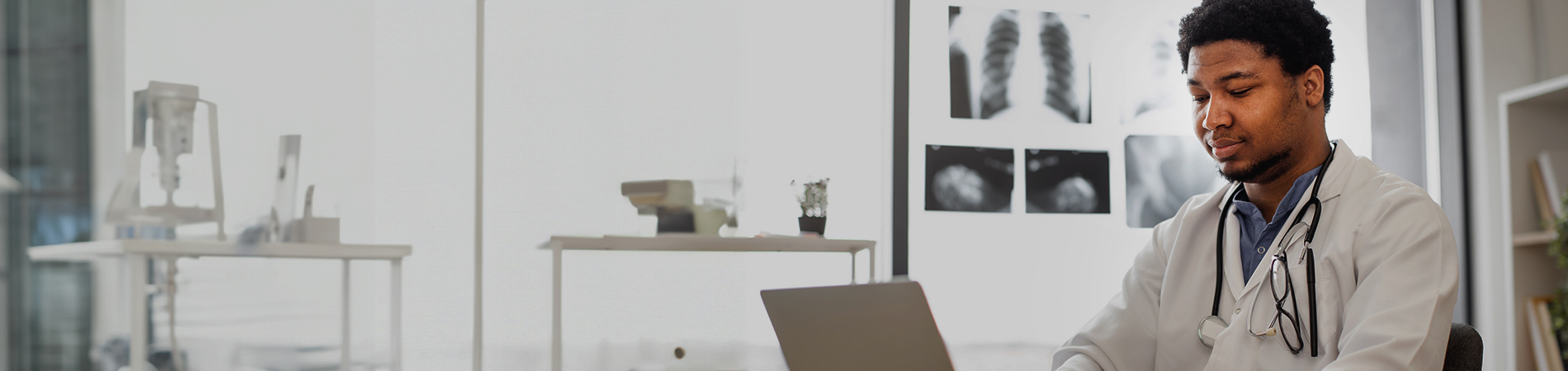 Male health care provider on computer in the lab