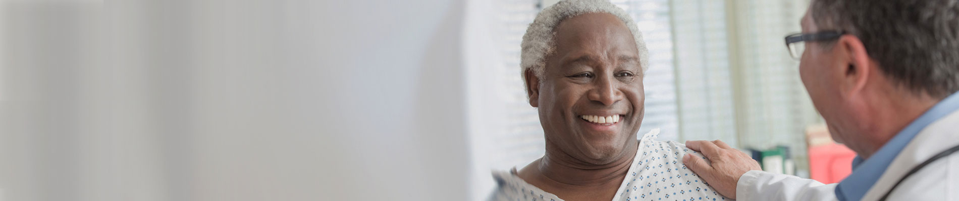 Doctor talking with elderly African American patient