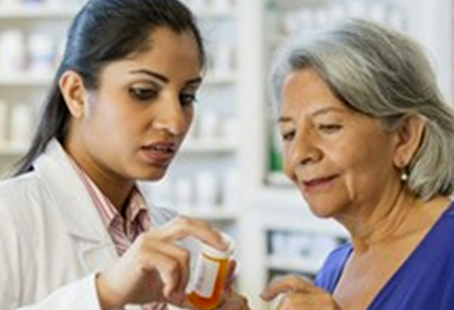 Pharmacist helping medicare member with prescription cost